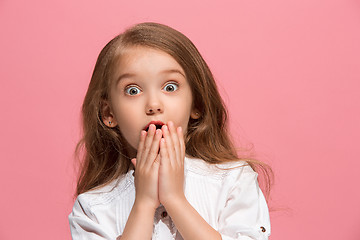 Image showing Beautiful teen girl looking suprised isolated on pink