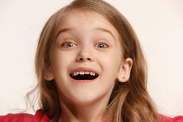 Image showing The happy teen girl standing and smiling against white background.