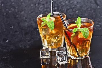 Image showing Two glasses with cold traditional iced tea with lemon, mint leav