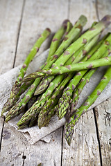 Image showing Bunch of fresh raw garden asparagus closeup and linen napkin on 