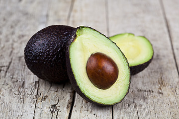 Image showing Fresh organic avocado on old wooden table background. Fresh avoc