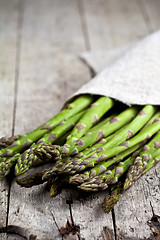 Image showing Bunch of fresh raw garden asparagus closeup and linen napkin on 