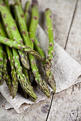 Image showing Bunch of fresh raw garden asparagus closeup and linen napkin on 