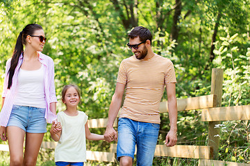 Image showing happy family walking in summer park