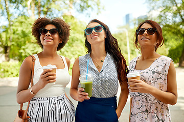 Image showing happy women or friends with drinks at summer park