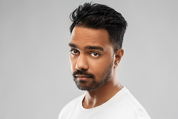 Image showing serious young indian man over gray background