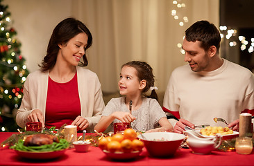 Image showing happy family having christmas dinner at home