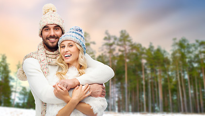 Image showing couple hugging over winter forest background