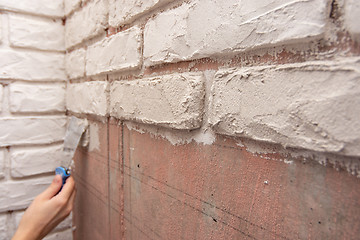 Image showing Designer bricks with a spatula on the wall