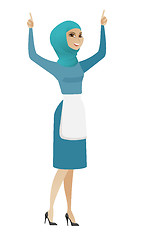 Image showing Young muslim cleaner standing with raised arms up.