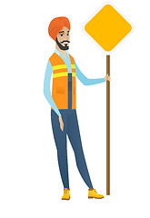 Image showing Young hindu road worker showing road sign.