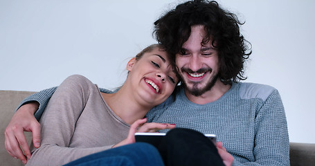 Image showing couple relaxing at  home with tablet computers