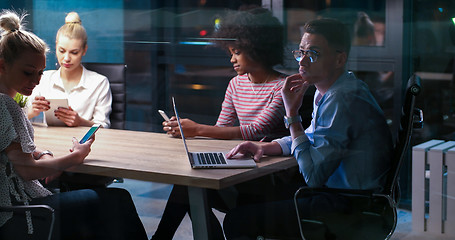 Image showing Multiethnic startup business team in night office