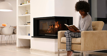 Image showing black woman at home reading book