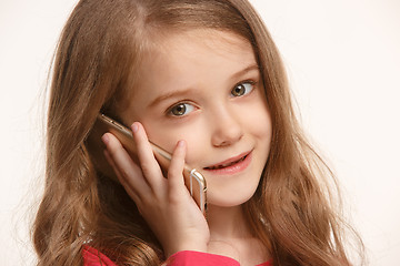 Image showing The happy teen girl standing and smiling against white background.