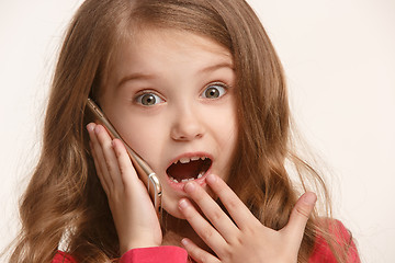 Image showing The happy teen girl standing and smiling against white background.