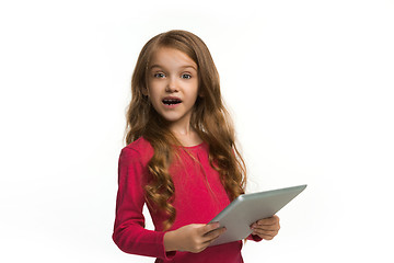 Image showing Little funny girl with tablet on white background