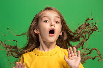 Image showing Beautiful teen girl looking suprised isolated on green