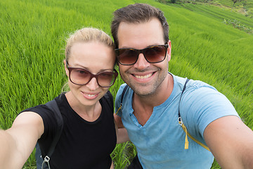 Image showing Beautiful love couple having fun taking selfie at beautiful Jatiluwih rice terrace plantations on Bali, Indonesia, south east Asia.