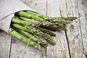 Image showing Bunch of fresh raw garden asparagus closeup and linen napkin on 