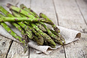 Image showing Bunch of fresh raw garden asparagus closeup and linen napkin on 