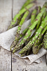 Image showing Bunch of fresh raw garden asparagus closeup and linen napkin on 