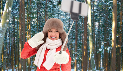 Image showing happy woman taking selfie over winter forest