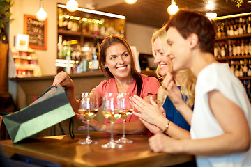 Image showing women with shopping bags at wine bar or restaurant