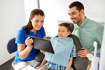 Image showing dentist showing tablet pc to kid at dental clinic
