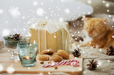 Image showing christmas gift, cookies and cat lying in bed