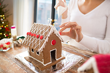 Image showing close up of woman making gingerbread house