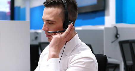 Image showing male call centre operator doing his job