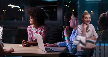 Image showing Multiethnic startup business team in night office