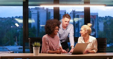 Image showing Multiethnic startup business team in night office