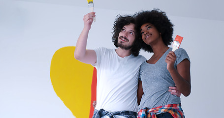 Image showing couple with painted heart on wall