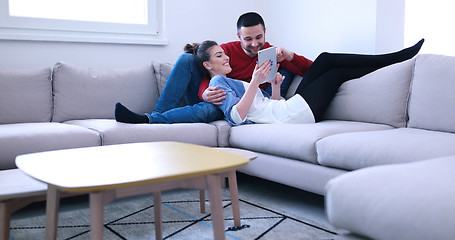 Image showing couple relaxing at  home with tablet computers