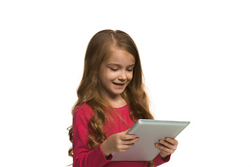 Image showing Little funny girl with tablet on white background