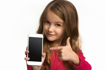 Image showing The happy teen girl standing and smiling against white background.