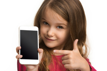 Image showing The happy teen girl standing and smiling against white background.