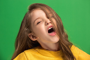 Image showing The happy teen girl standing and smiling against green background.