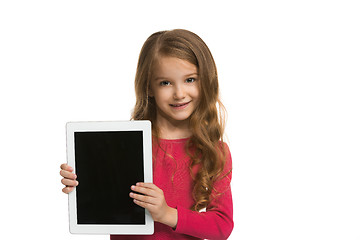 Image showing Little funny girl with tablet on white background