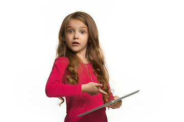 Image showing Little funny girl with tablet on white background