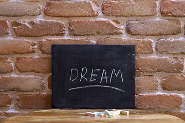 Image showing Black board with the word DREAM drown by hand on wooden table on