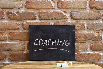 Image showing Chalk board with the word COACHING drown by hand on wooden table