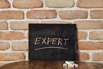 Image showing Chalk board with the word EXPERT drown by hand on wooden table o