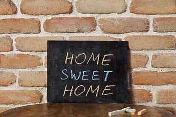 Image showing Black chalkboard with the phrase HOME SWEET HOME drown by hand o