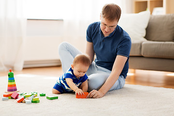 Image showing happy father with baby son playing toys at home