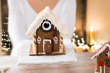 Image showing close up of woman with christmas gingerbread house