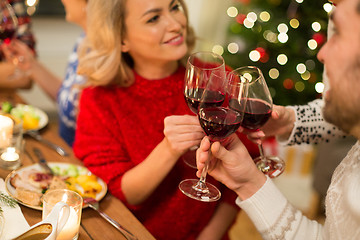 Image showing close up of friends with wine celebrate christmas