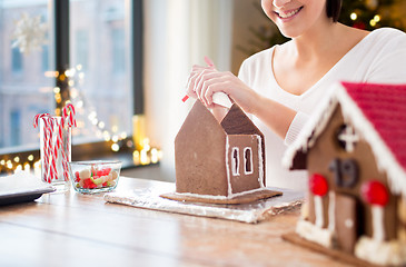 Image showing woman making gingerbread houses on christmas